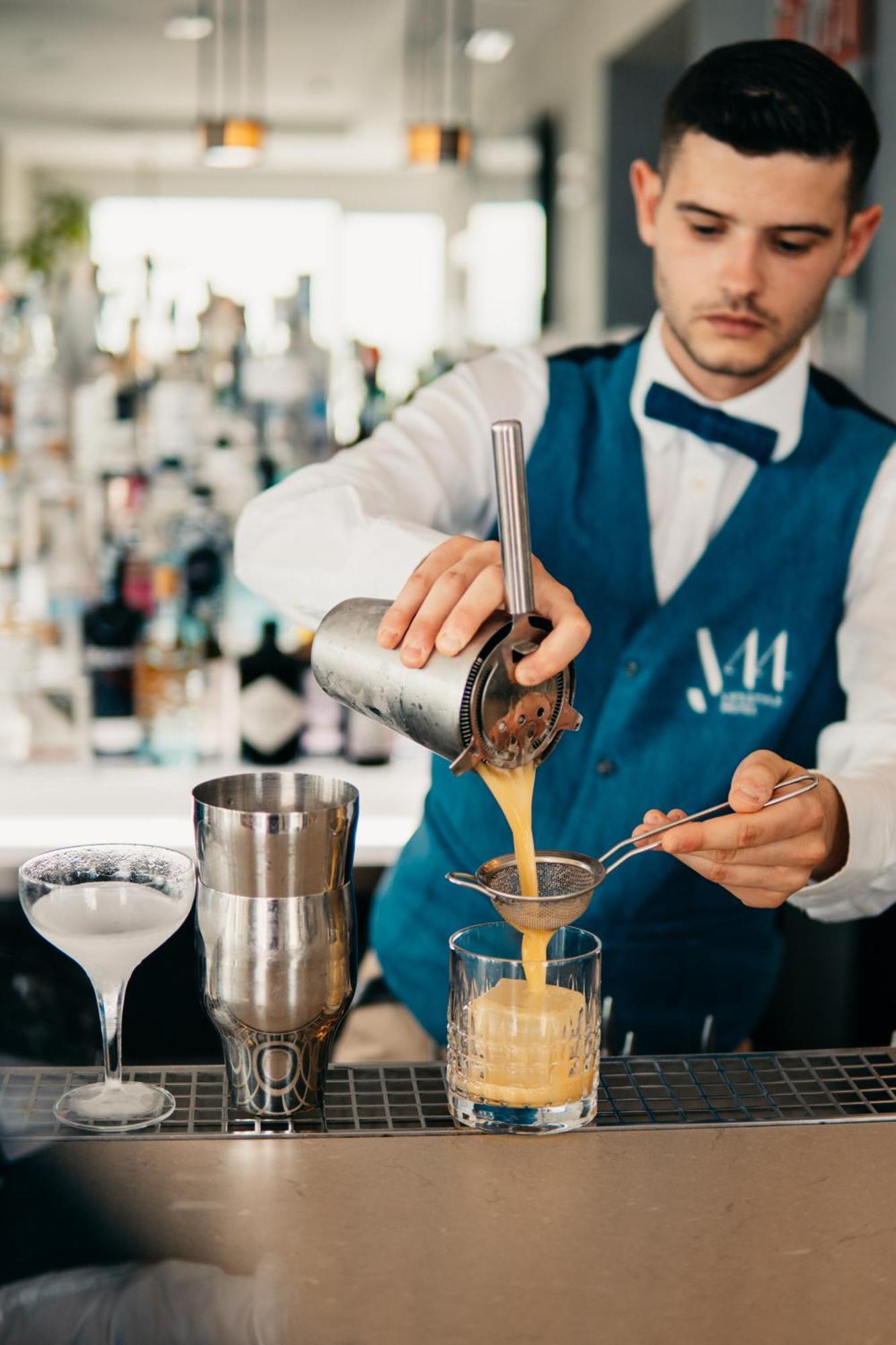 J44 Lifestyle Hotel Лідо-ді-Єзоло Екстер'єр фото A bartender straining a cocktail